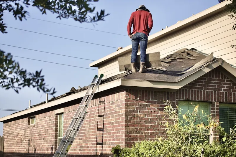 Professional roofer working on a residential roof in Main Street Merchants